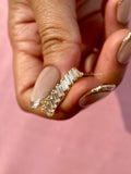 Woman wearing the minimalist yellow gold baguette wedding band on her finger