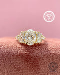 Vintage oval diamond cluster ring featuring marquise and pear side stones in 14k yellow gold