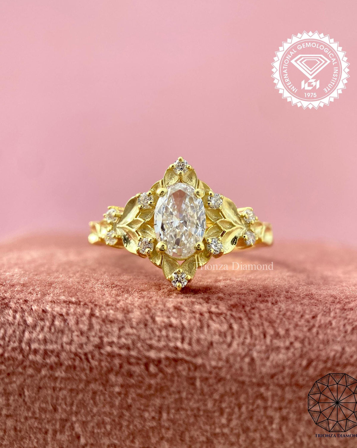Vintage oval diamond engagement ring featuring a yellow gold leaf and cluster design