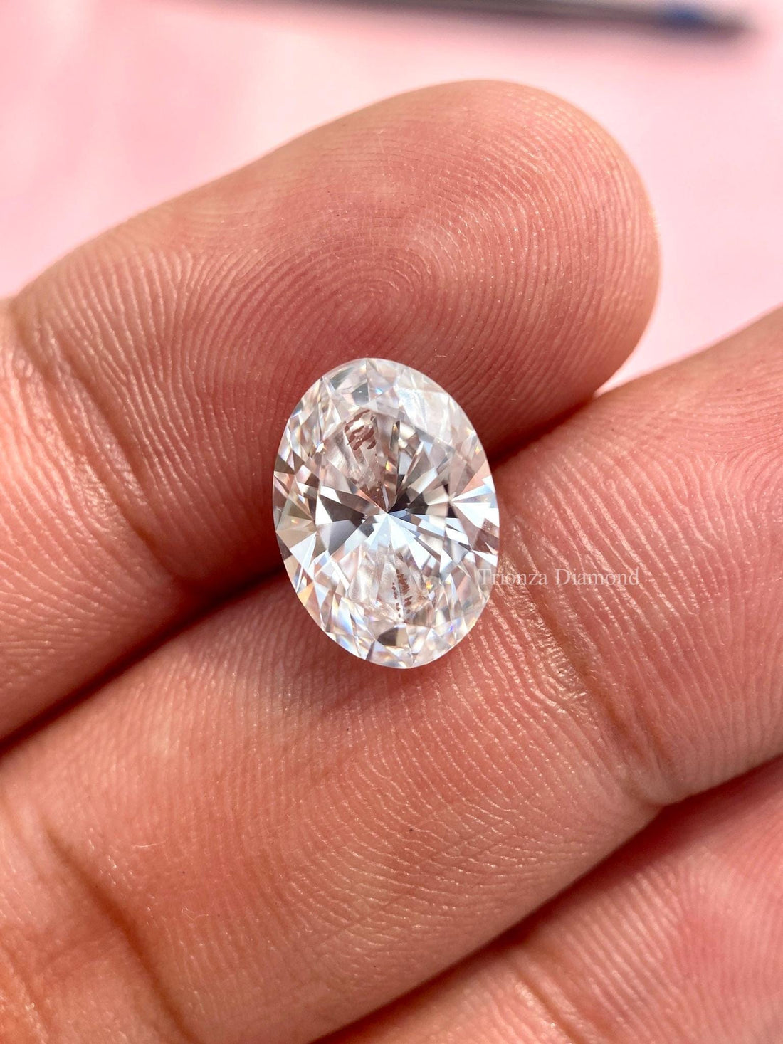 Oval cut lab grown diamond displayed to showcase its D color and VVS2 clarity