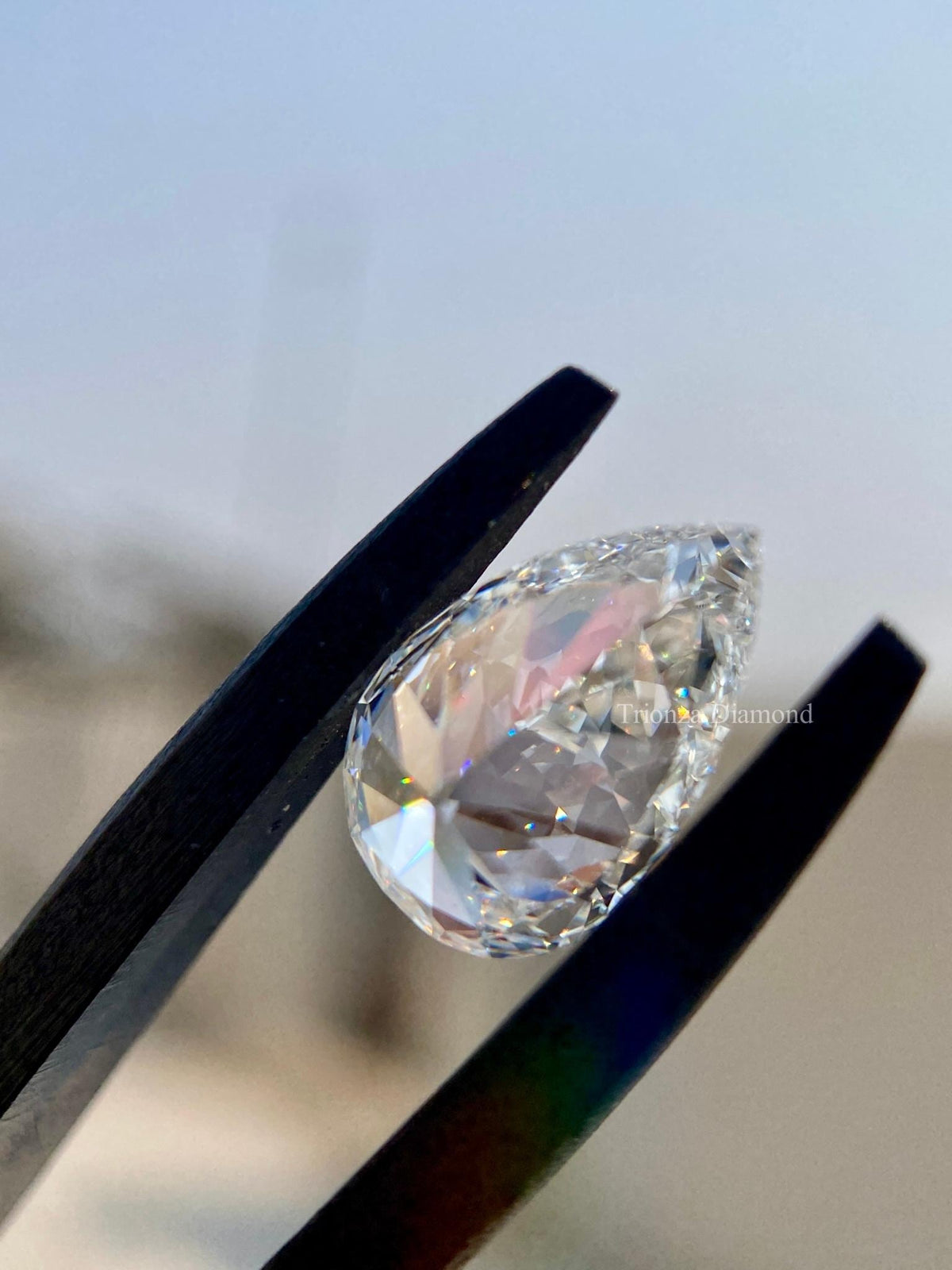 Pear shaped CVD diamond positioned to display its excellent polish and symmetry