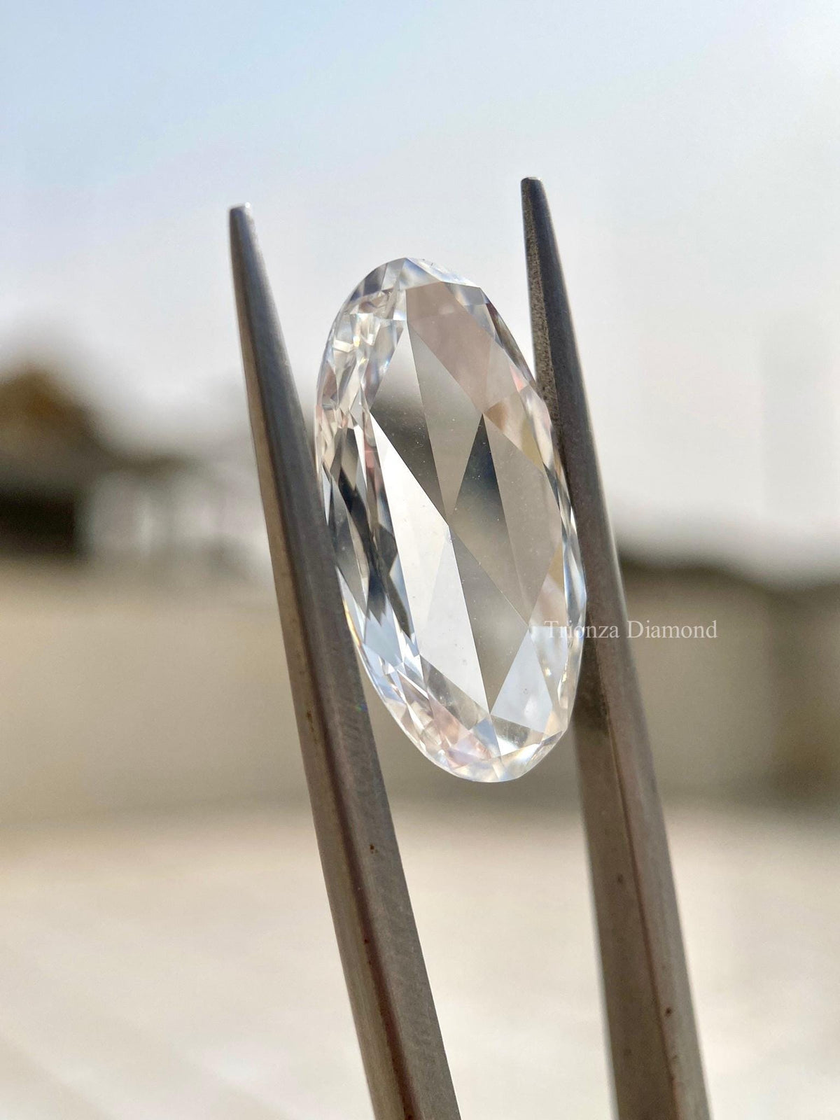 Side view of the oval rose cut diamond showing its 1.68 mm depth measurement