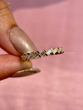Woman wearing the half eternity wedding band alongside other stacked rings
