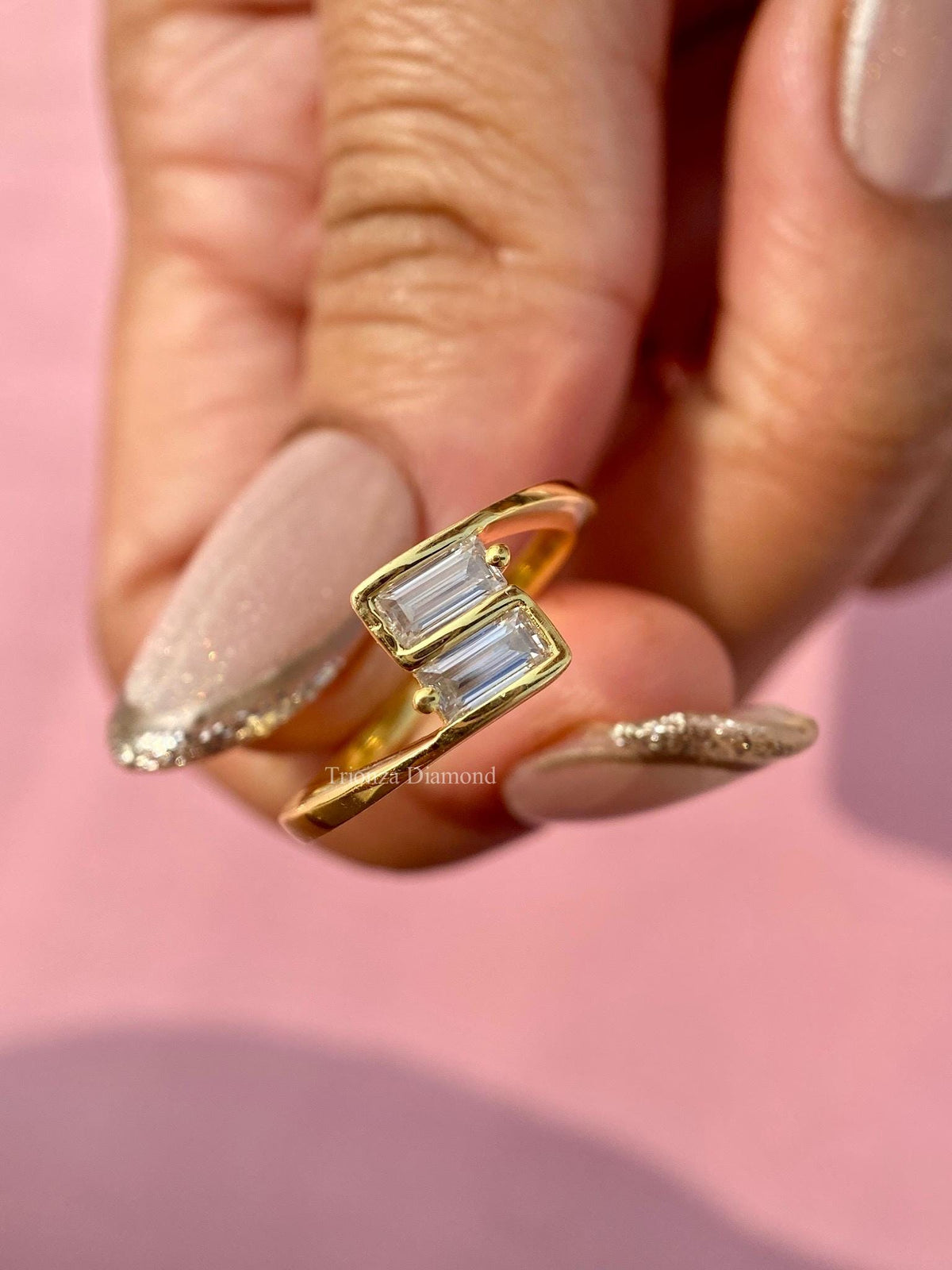 East-west baguette engagement ring featuring two bypass set lab grown diamonds in 14K gold