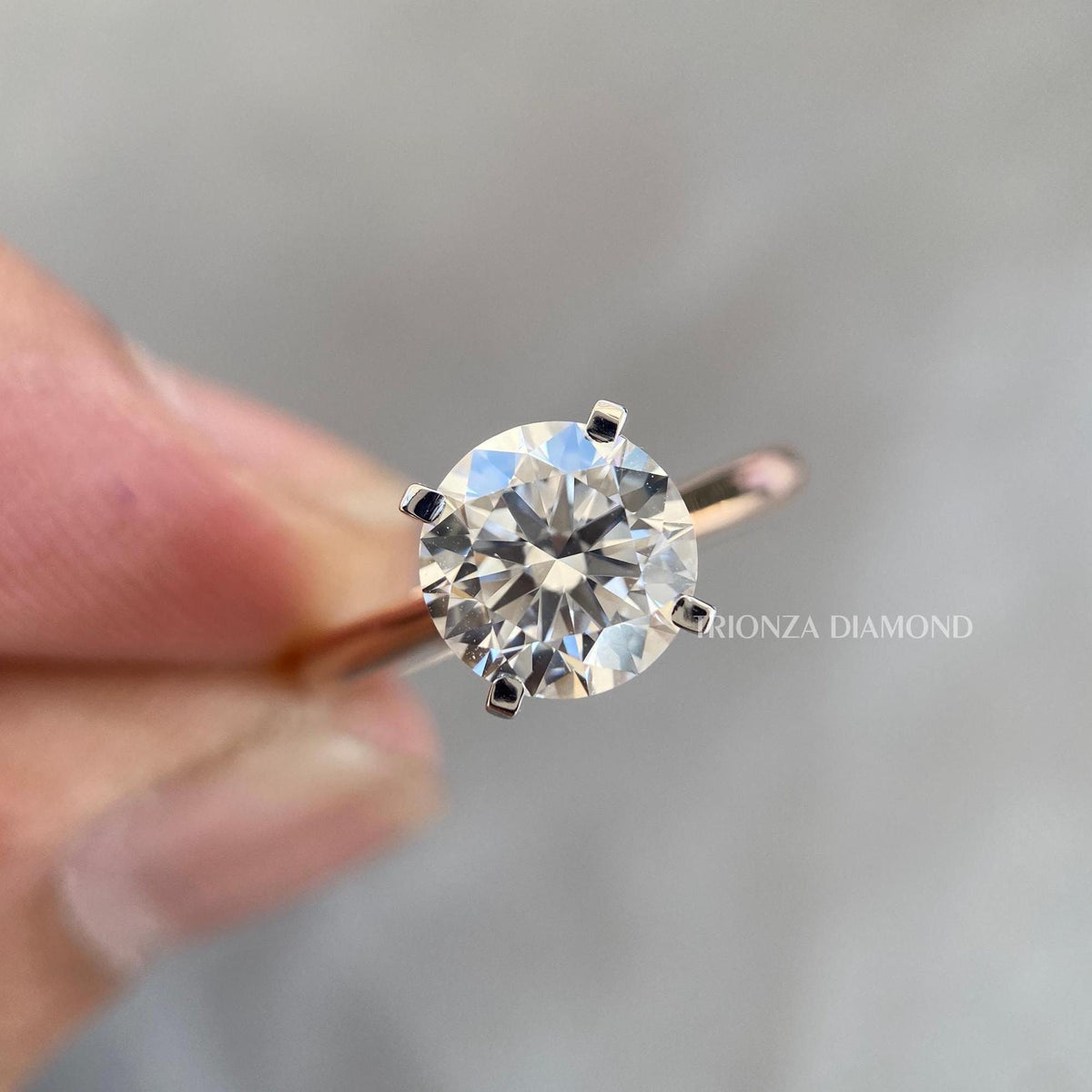 Round brilliant lab grown diamond solitaire ring set in 14K yellow gold with a minimalist band