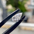 Pear step cut diamond measuring 12.00 by 7.53 by 4.18 mm shown from a side angle