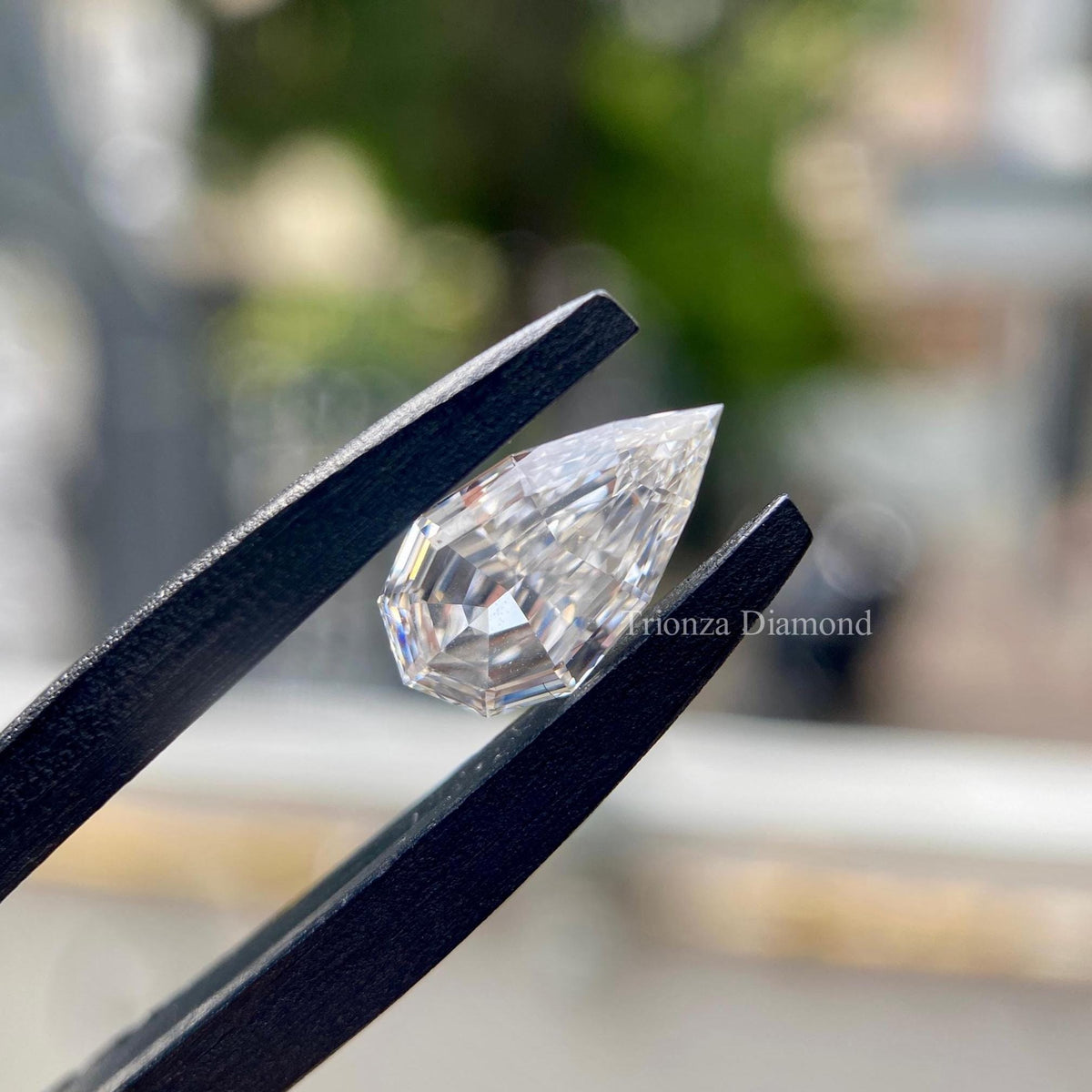 Pear step cut diamond measuring 12.00 by 7.53 by 4.18 mm shown from a side angle