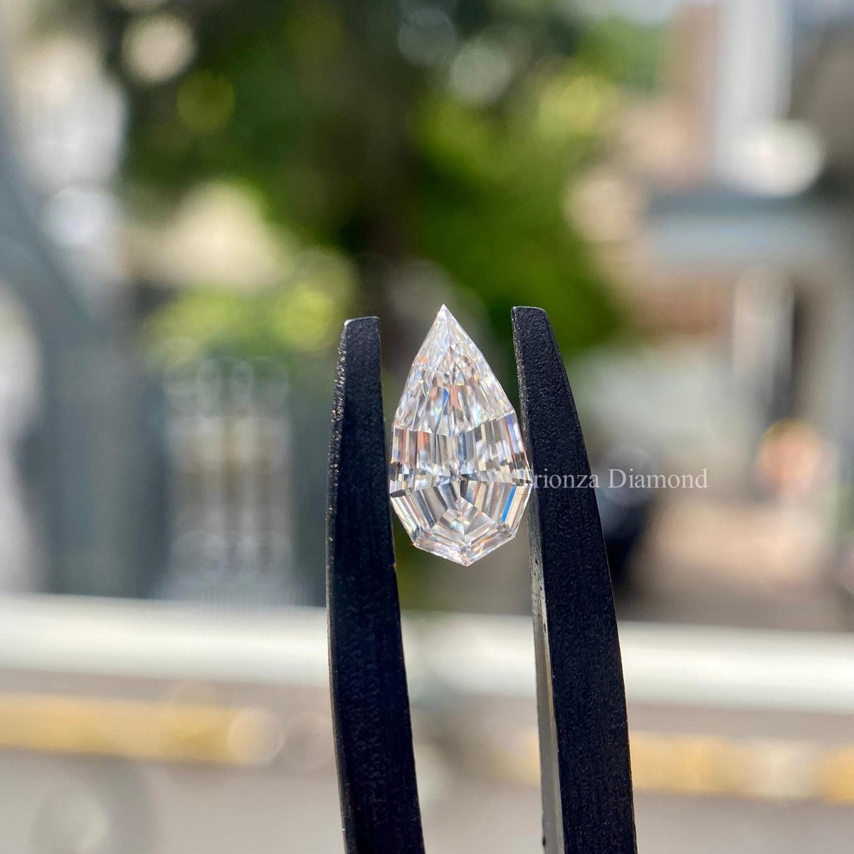 Close-up of the 2.80 CT pear shaped diamond highlighting its F color and VVS2 clarity