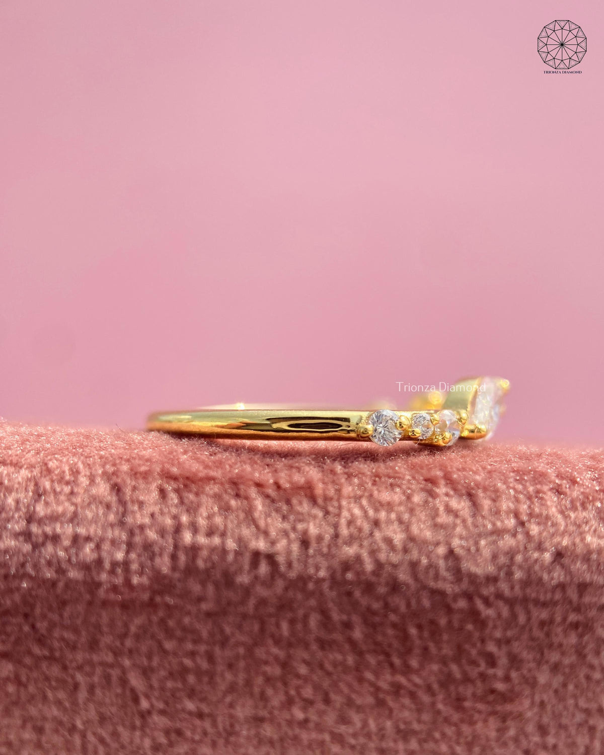 Pave diamond eternity band in yellow gold surrounding the bypass ring design