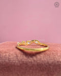 Yellow gold twist ring displayed to highlight the delicate pave diamond details
