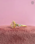 Close-up of the three stone pear diamond ring showing the botanical leaf vine details