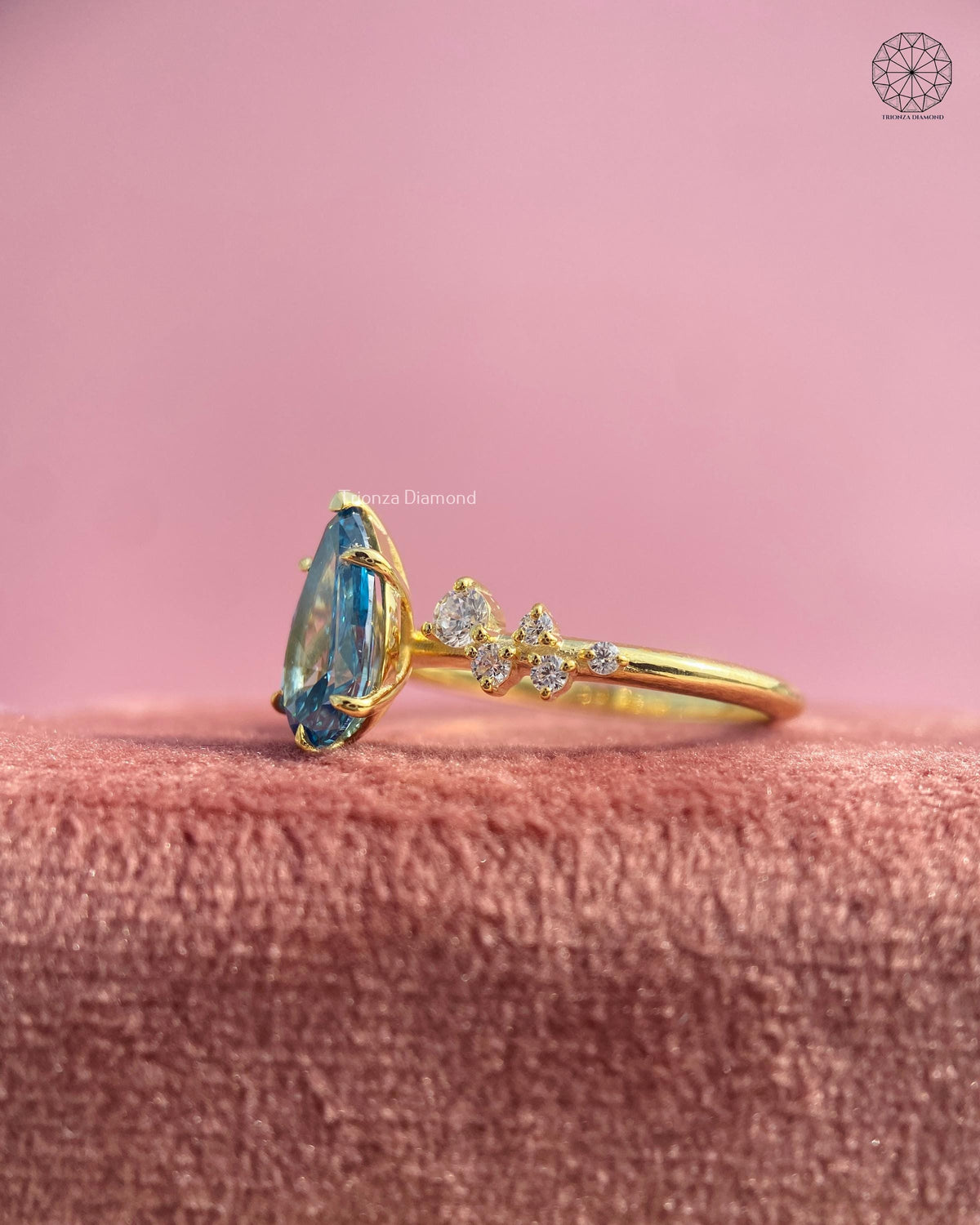 Teardrop blue diamond ring captured from a side angle to highlight its statement design