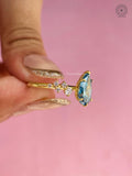 Blue pear ring displayed in a jewelry box to show its statement bridal styling