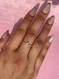 Side view of the marquise diamond ring highlighting the round accent clusters on the band