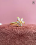Pear diamond ring displayed to highlight the modern floral design and yellow gold band