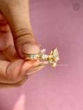 Toi et moi style ring showcasing the pear cut center stone and floral cluster setting