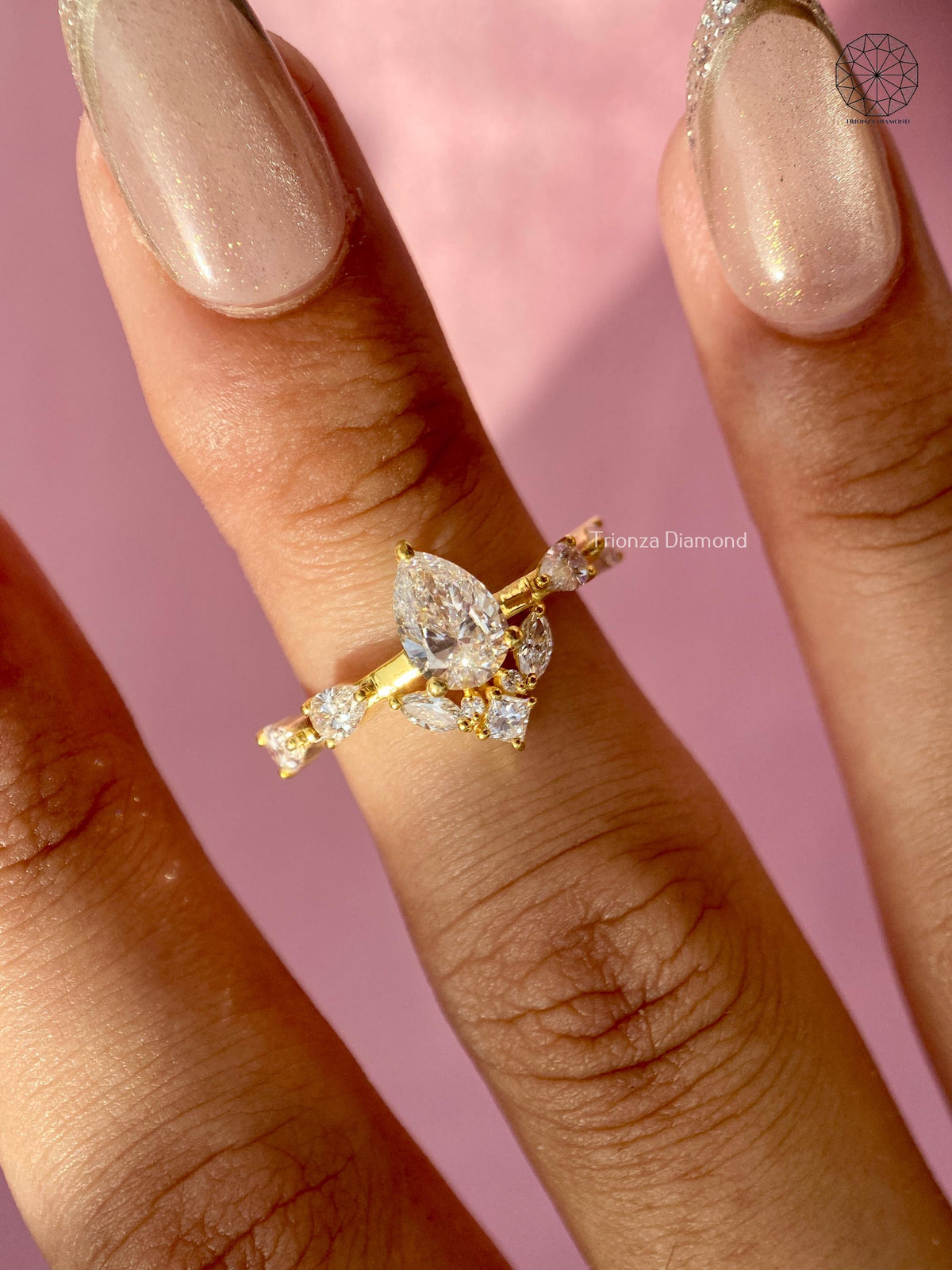 Woman wearing the pear diamond cluster ring, close-up on her hand