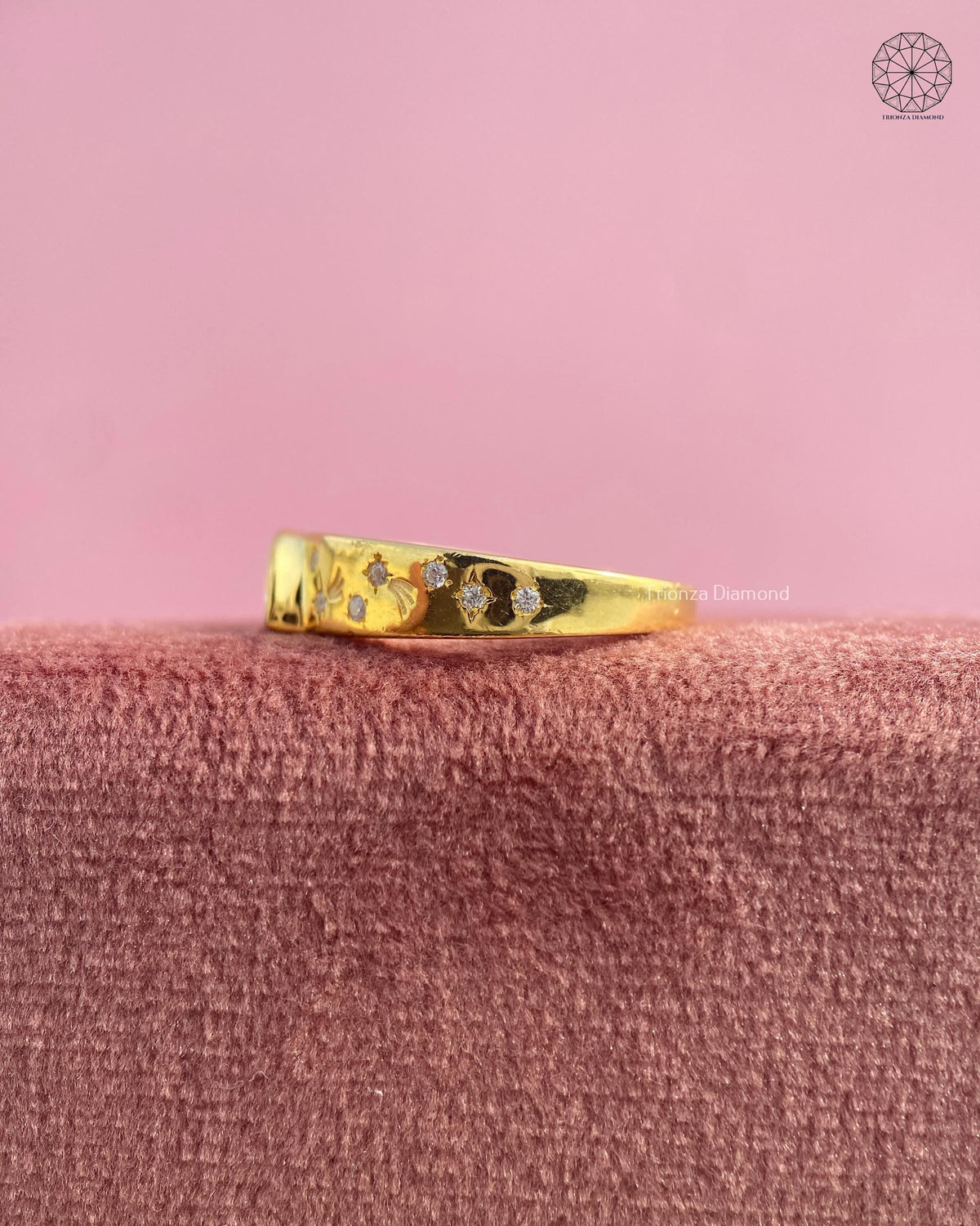 Yellow gold statement ring showcasing a low profile bezel set diamond design