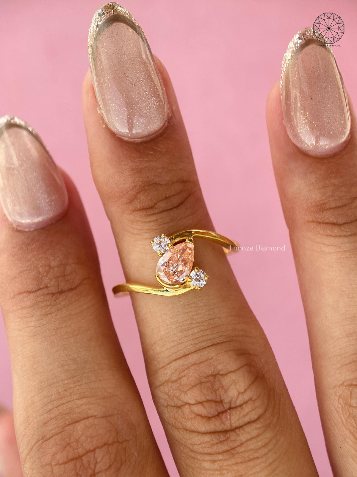 Woman wearing the orange pear diamond bypass ring, showcasing its unique bridal design