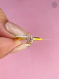 High polish yellow gold ring showcasing the pear brilliant diamond from the side