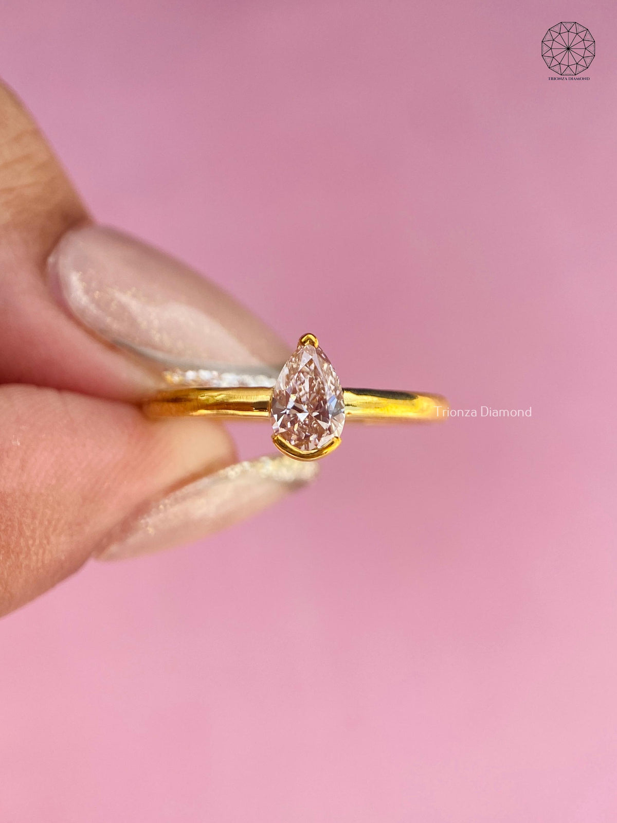 High polish yellow gold ring showcasing the pear brilliant diamond from the side