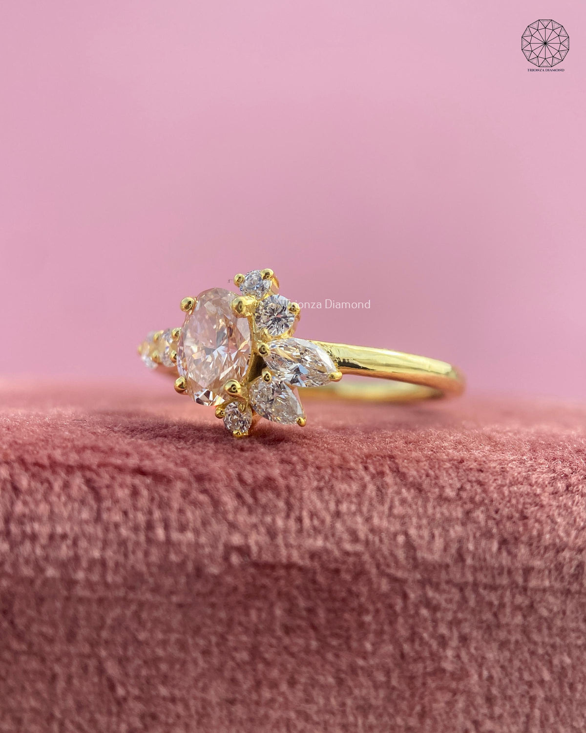 Yellow gold ring showcasing the prong set oval champagne center stone in detail