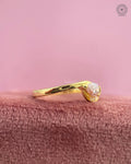 Close-up of the semi bezel bypass swirl setting holding the pink pear diamond