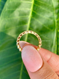Woman wearing the baguette diamond eternity band paired with other stacking rings