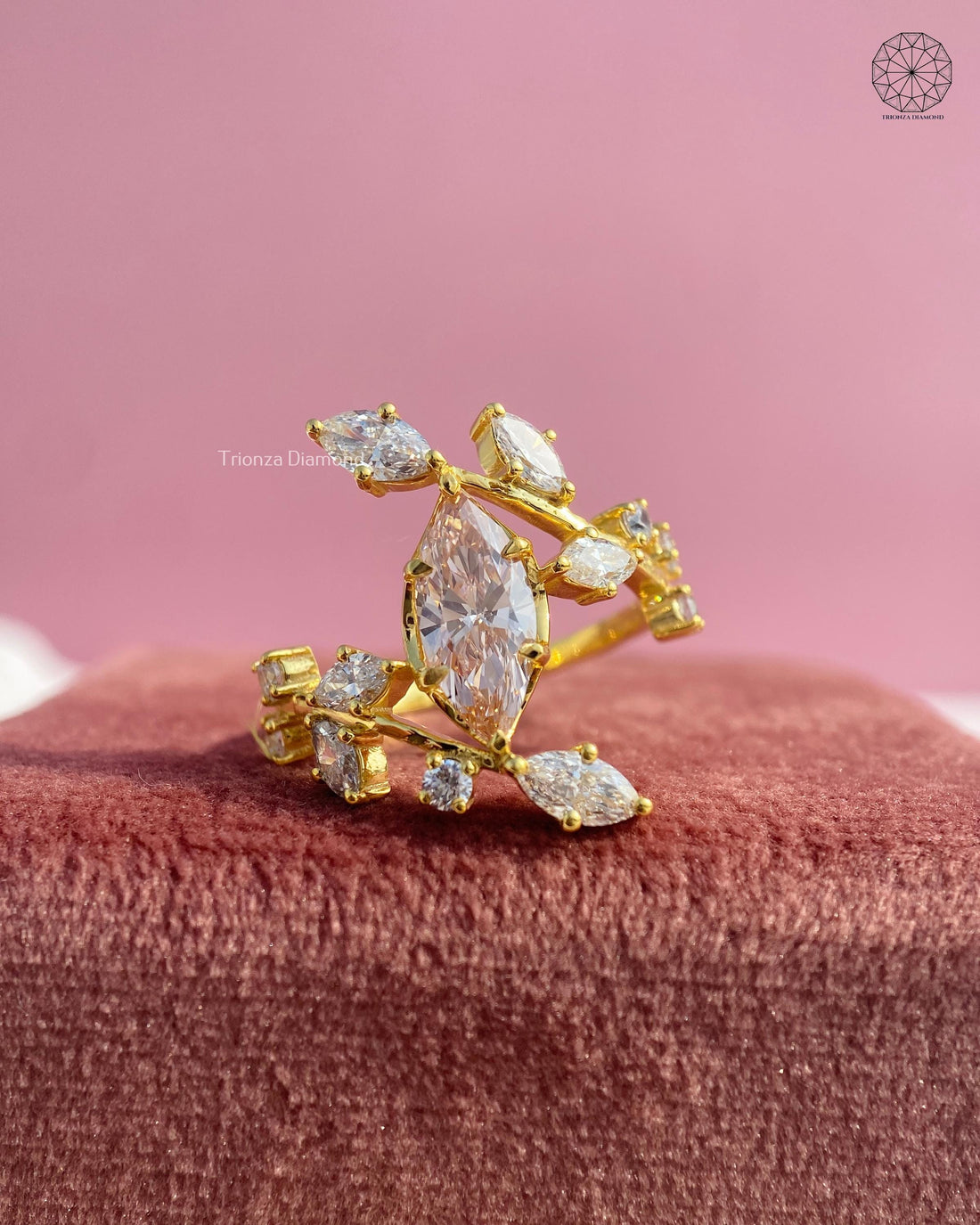 Marquise cut lab grown diamond cluster ring featuring a yellow gold botanical vine leaf design