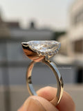 Side view of the 14K gold ring emphasizing the prong setting around the marquise diamond