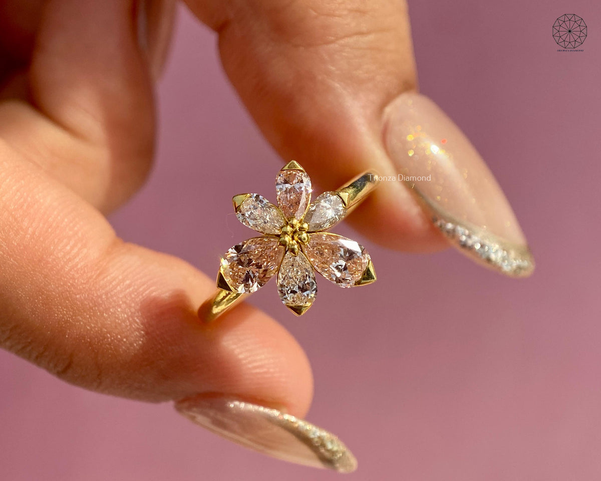 Yellow gold floral cluster ring featuring six pear cut lab grown diamonds and pink tourmaline accents