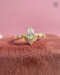 Pear cut lab grown diamond engagement ring featuring a yellow gold floral cluster design