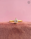 Pear cut lab grown diamond engagement ring set in a minimalist yellow gold band