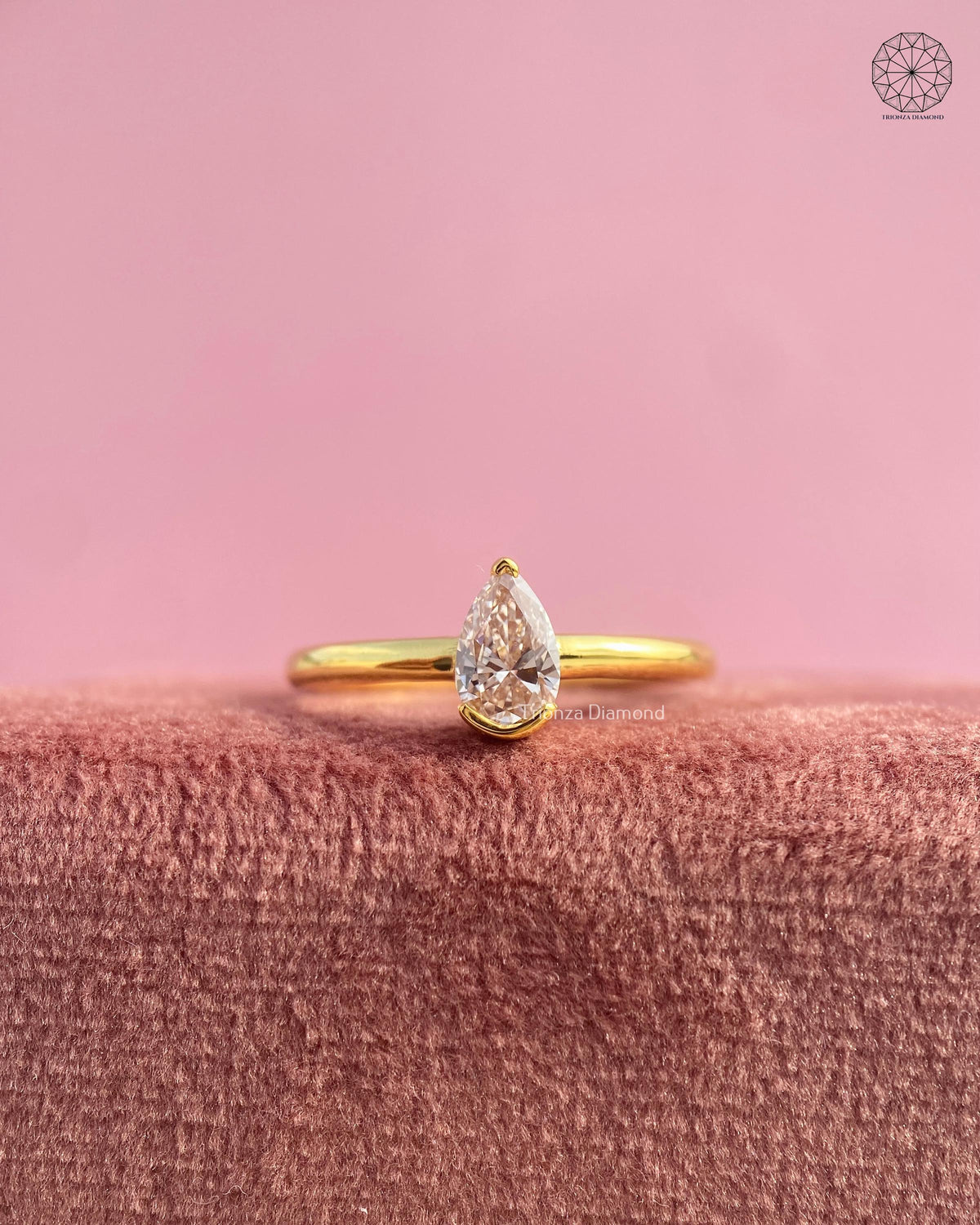 Pear cut lab grown diamond engagement ring set in a minimalist yellow gold band