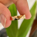 Bold chevron band in solid 14K gold showcasing a V shaped moissanite design