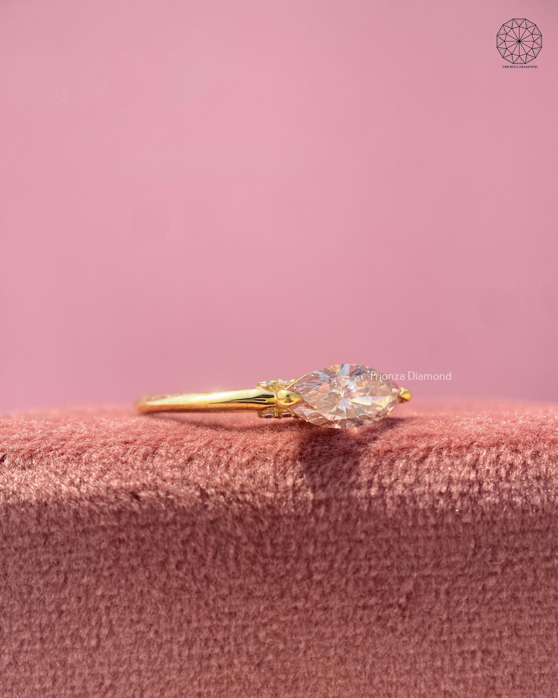 East west marquise lab grown diamond ring displayed in yellow gold with a slim band