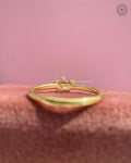 Slim gold band pinky ring showcasing an east west pear cut pink diamond