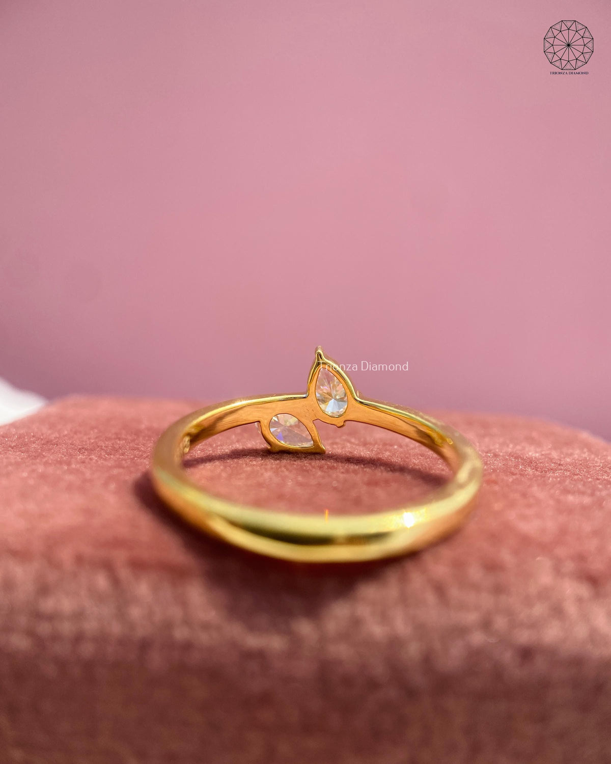 Woman wearing the dainty pear diamond toi et moi ring on her hand