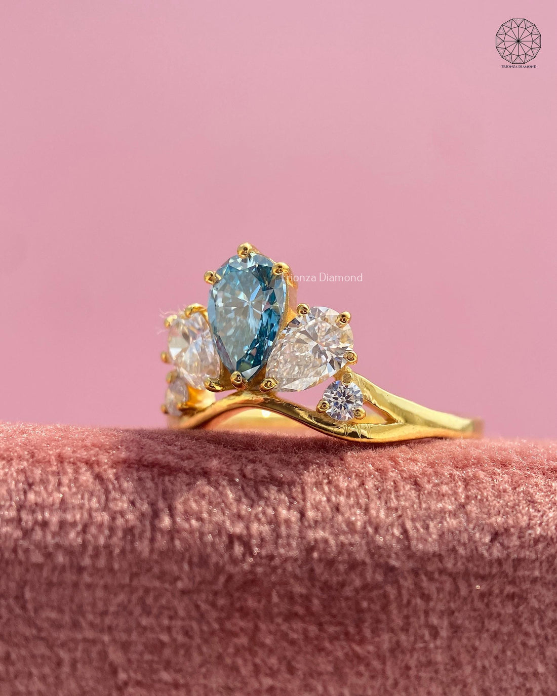 Pear cut fancy blue lab grown diamond cluster ring displayed to show its tiara style setting