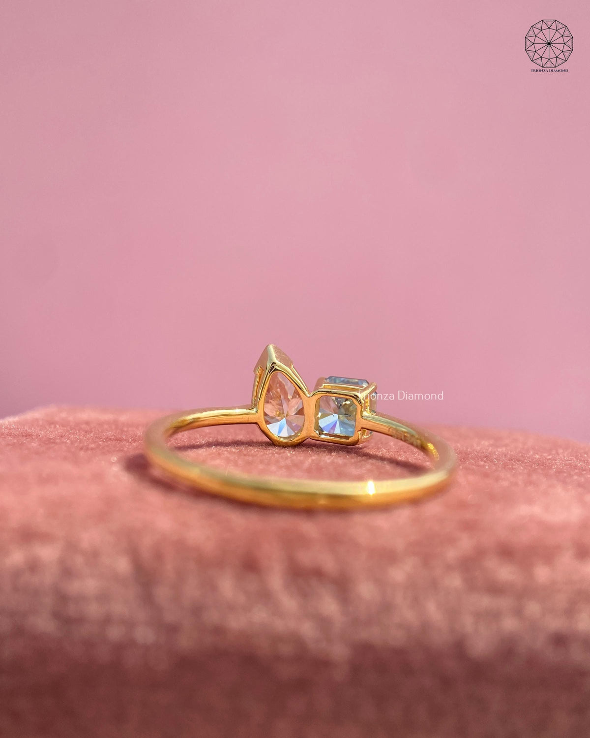 Pink pear cut diamond and blue Asscher cut diamond set side by side in a toi et moi design