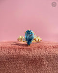 Close-up of the cluster shoulder detailing surrounding the pear cut blue diamond ring