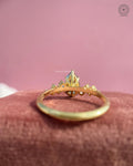Top view of the yellow gold ring highlighting the pear cut blue gemstone center stone