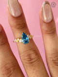 Woman wearing the pear blue lab grown diamond ring on her hand for a romantic look