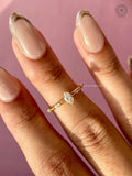 Yellow gold engagement ring displayed to show the slim band and accent cluster details