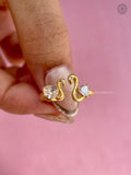 Swan motif ring showcasing prong set trillion and pear cut lab grown diamonds