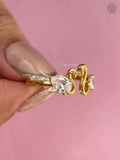 Woman wearing the yellow gold toi et moi ring with pear and trillion cut diamonds