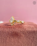 Close-up of the prong set pear diamond showing side marquise and princess cut stones