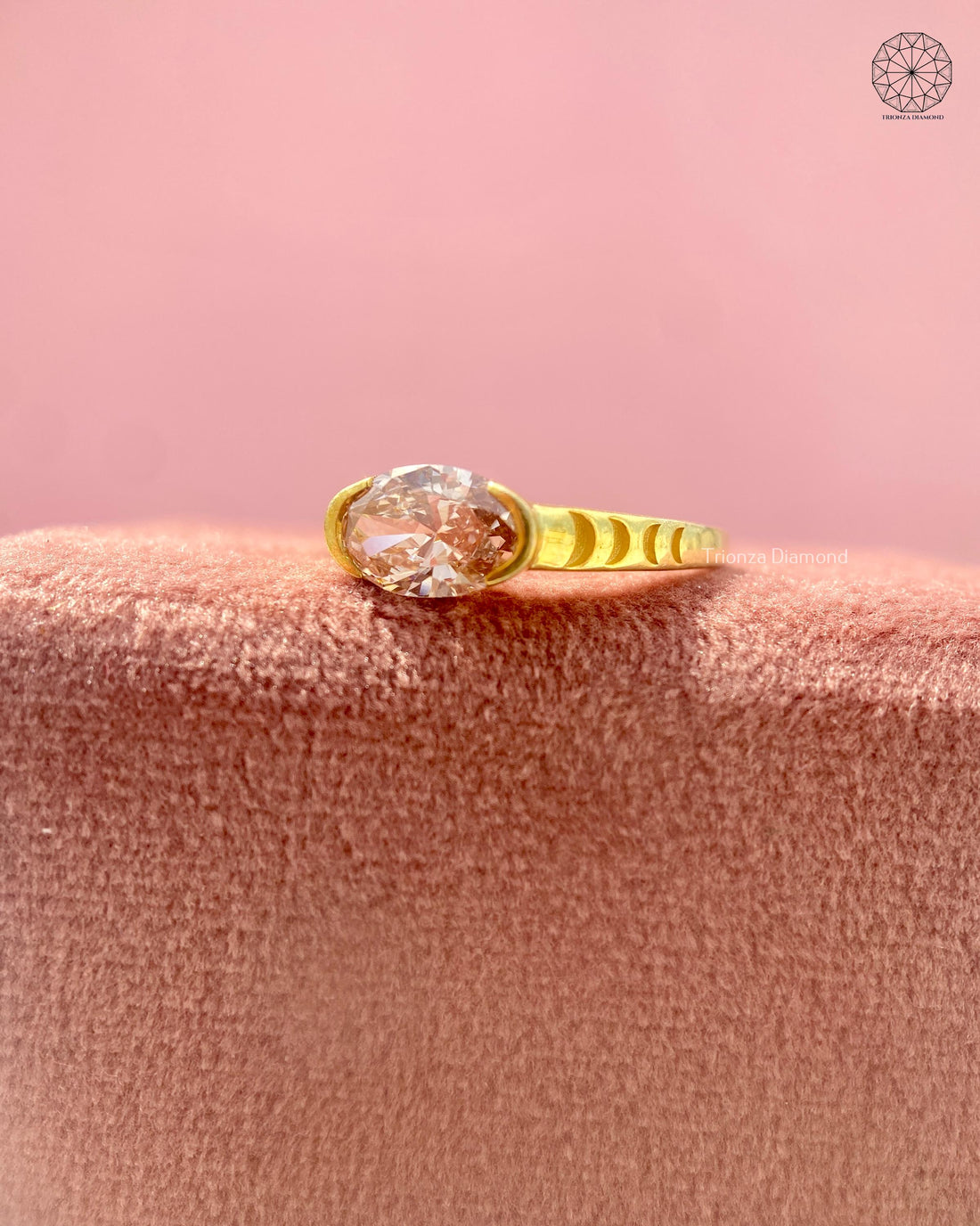 Pink oval lab grown diamond ring with semi-bezel setting in yellow gold fluted band
