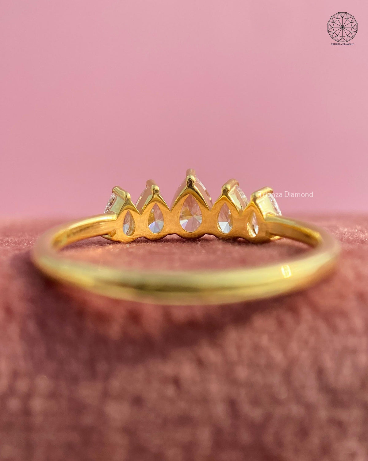 Five stone pear diamond ring displayed to highlight its VVS VS1 clarity and excellent polish