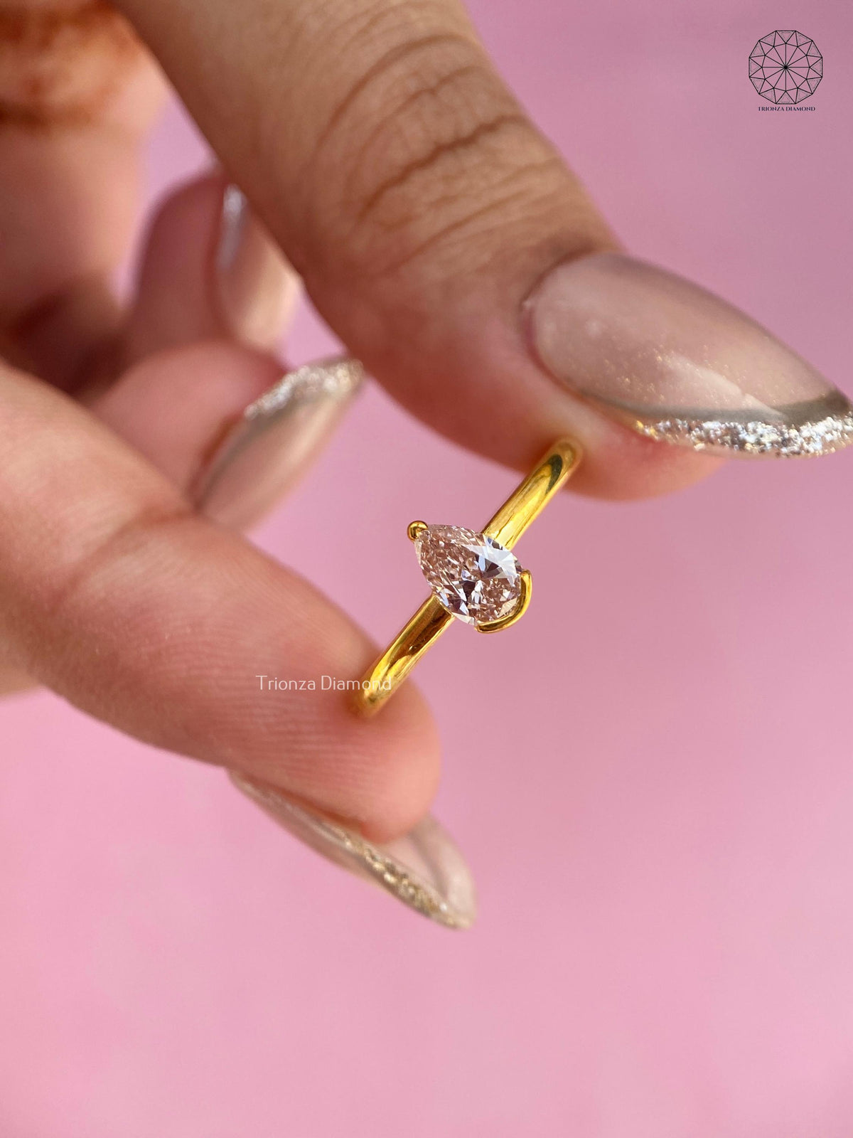 Close-up of the V tip setting securing the 0.40 CT pear brilliant diamond
